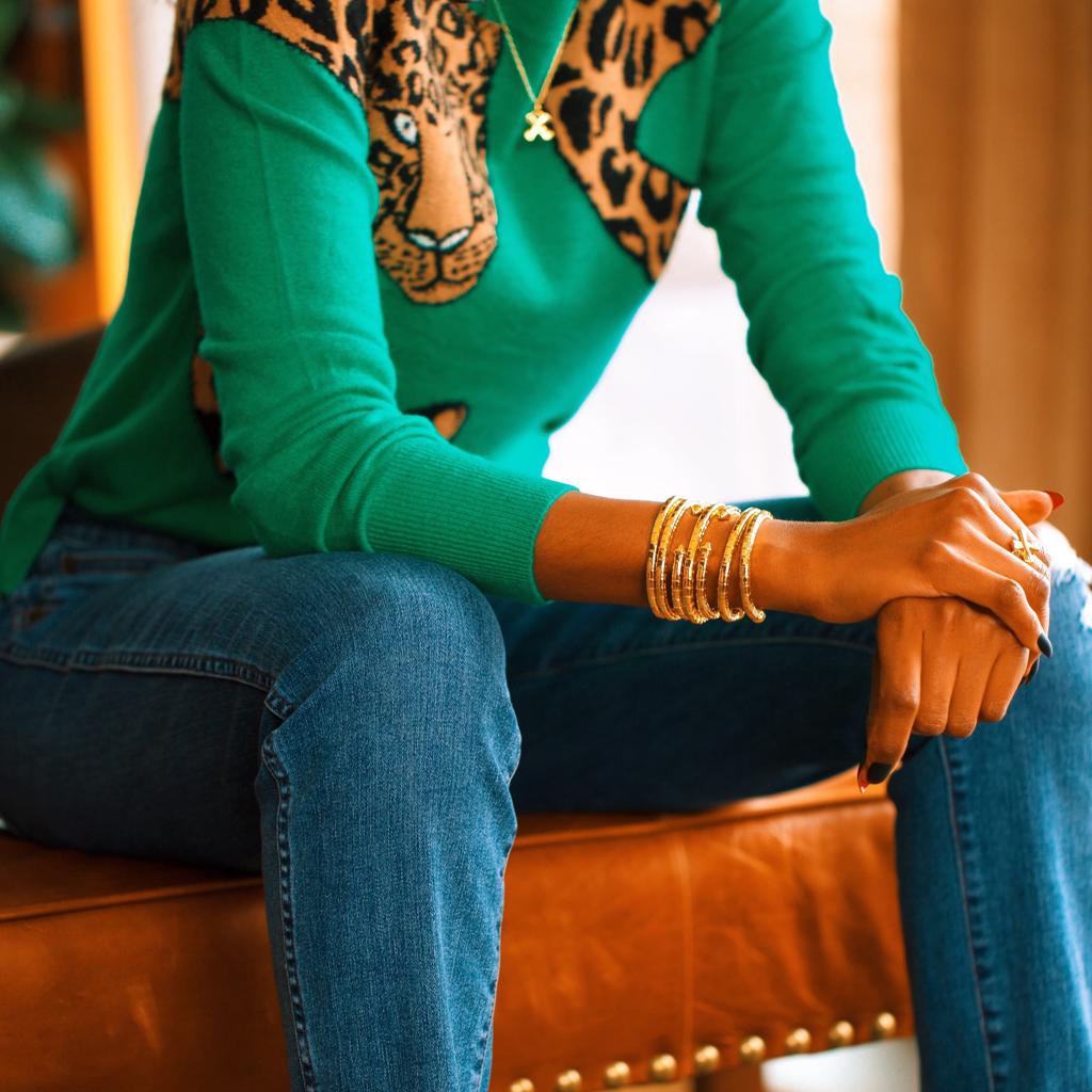 Model Wearing Dalasini Wakanda Gold Pendant Necklace and Ring and Isiro Gold Vertebrae Bracelets