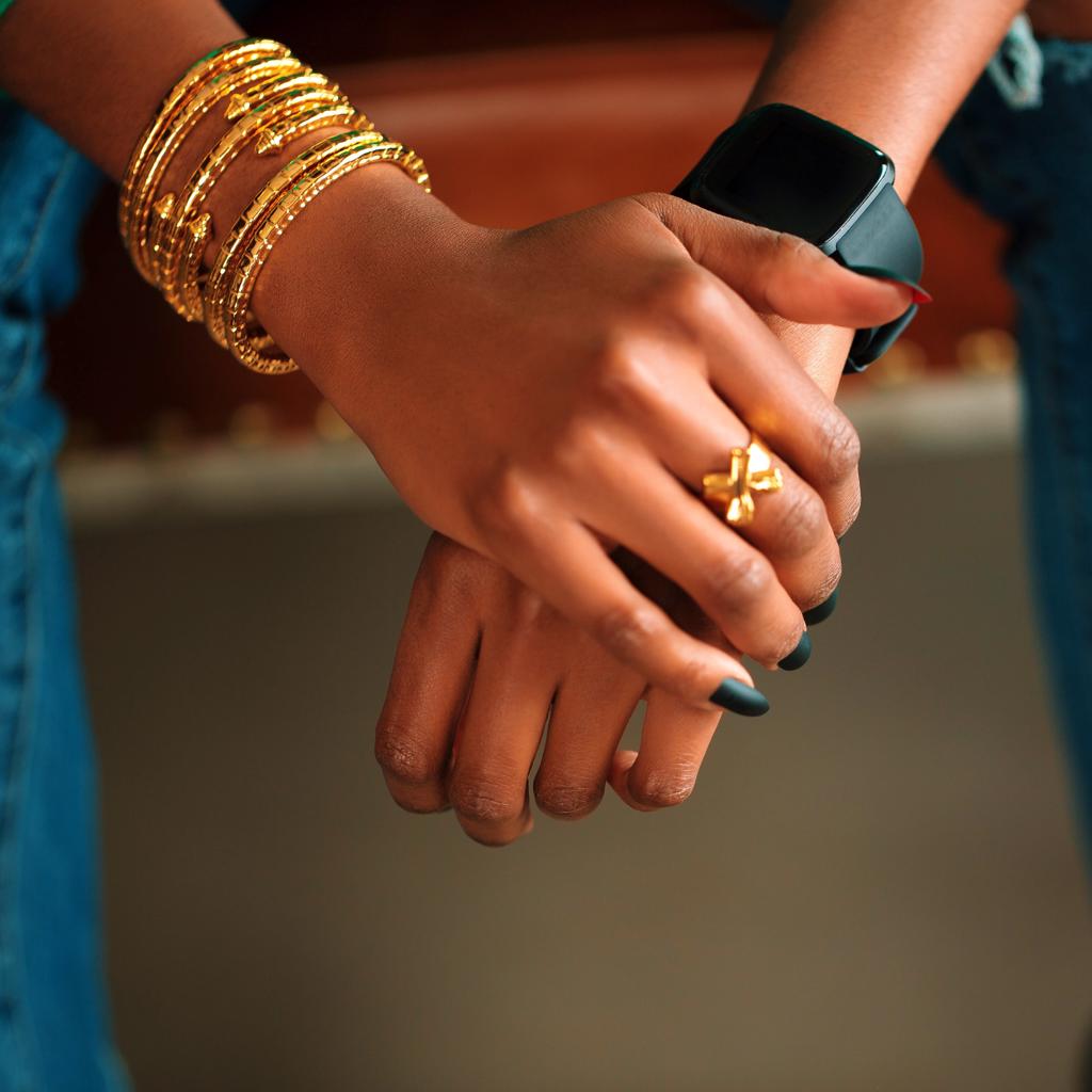 Model Wearing Dalasini Isiro Gold Vertebrae Bracelets and Wakanda Gold Ring
